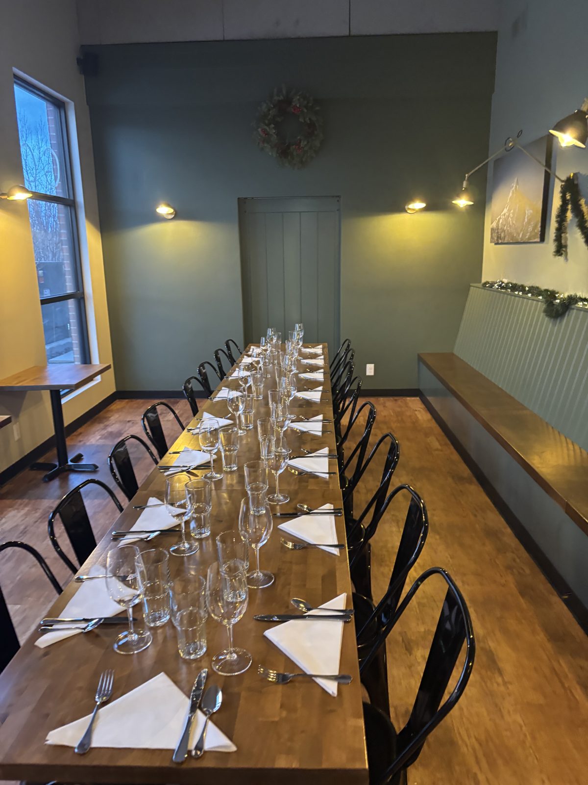 The full length of the back room, set for a dinner party